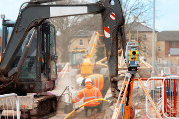 New road construction and kerb line installation by groundworkers on new housing development...