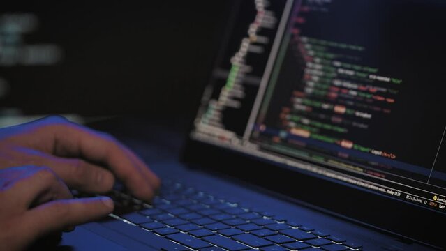 Programmer's hands and laptop keyboard close-up. Working on a project on a laptop.