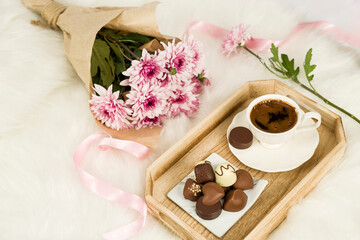 Obraz na płótnie Canvas Bunch of flowers next to chocolate and Turkish coffee