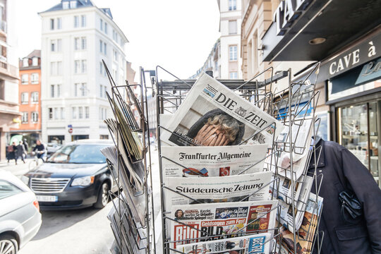 Paris, France - Apr 11, 2022: Die Zeit German newspaper with headline breaking news feature with Ukraine woman crying during the war in Ukraine - man shopping for press in background