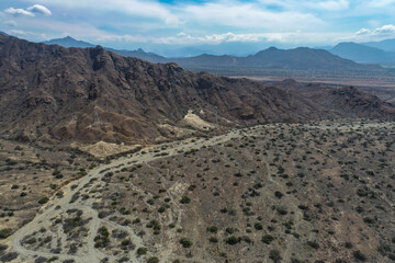 arid mountains in them you can see power towers and highways.