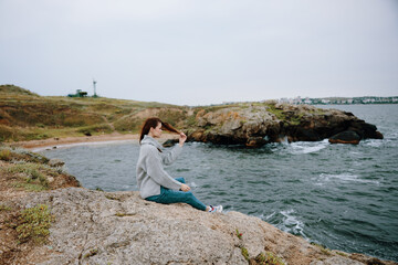 Naklejka na ściany i meble portrait of a woman sweaters cloudy sea admiring nature female relaxing