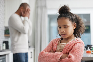 Whats a dad to do when your daughter wont talk to you. Shot of a little girl looking unhappy after a disagreement with her father at home.