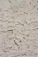 Texture of plastered old wall with cracks. Vertical photo.