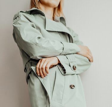 woman in an elegant trench coat, street style fashion details. close up, young fashion blogger wearing autumn trench coat