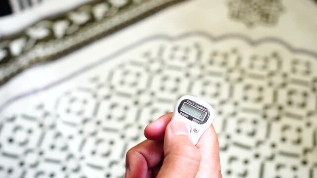 Digital Counter for prayer beads in a man's hand