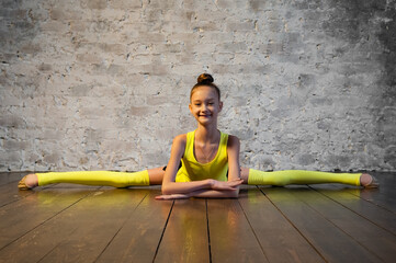 Young gymnast girl stretching and training. Sport and healthy lifestyle concept