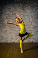Fototapeta na wymiar Young gymnast girl stretching and training. Sport and healthy lifestyle concept