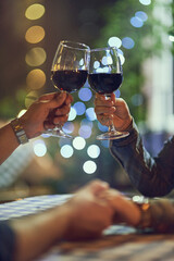 Heres to our everlasting love. Cropped shot of a couple clinking their glasses while on a romantic date.