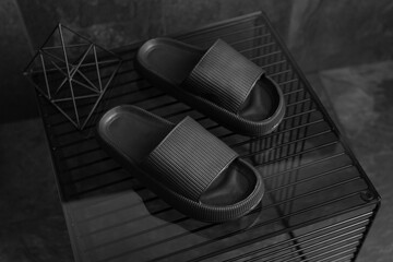Fototapeta na wymiar Black Sandals shoes. Black flip flops on dark black background.