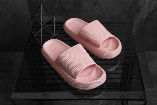 Colorful pink Sandals shoes. Pink flip flops on dark black background