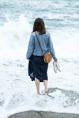 A woman walking into the sea