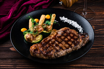 Grilled striploin steak with spices and herbs, strip steak New York strip.