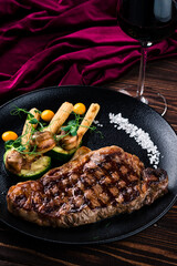 Grilled striploin steak with spices and herbs, strip steak New York strip.