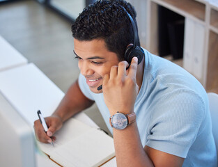 Neednt leave your bed to have your needs met. Above shot of a young man working in a call center in...