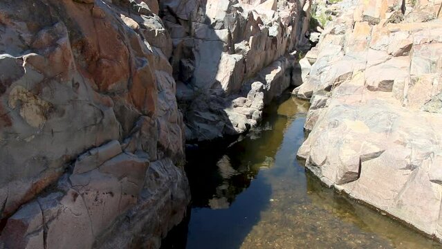 An interesting shot of a small flow of water between rocky walls. Small slithery creatures have been found in this desolate area.