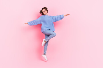 Full length photo of cheerful pretty person hands flight toothy smile isolated on pink color background