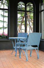 Empty chair and table set at summer pavilion