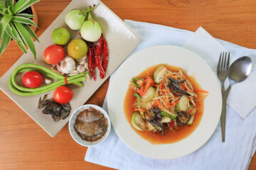 Papaya Salad (Som Tam) the traditional Thai foods on wood table background. Most wanted popular food in Thailand