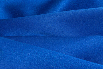 Close up of blue draped textile material.