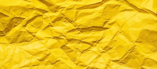 abstract background from crumpled yellow paper, horizontal