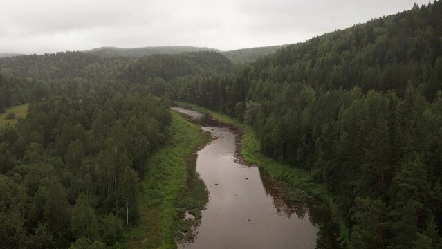 Beautiful river among green pine tree forest. Nature of South Ural region at Bashkortostan, Russia