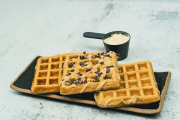 protein waffles with chocolate and peanut butter. protein powder and plate. White background. Copy space.