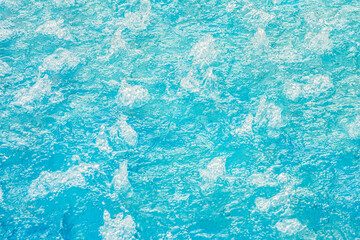 blue turquoise water in a bubbling pool with hydro massage, texture background of clear water
