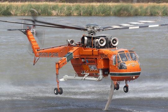 Bundoora, Australia - December 30, 2019: Erickson Air Crane helicopter filling with water to fight a bushfire in the Melbourne suburb of Bundoora.
