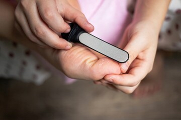 foot cleaning with micro stone toe brush to remove small cracks, scratches and pimples for healthy feet