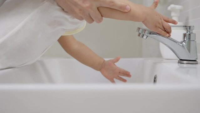Child  Turn off the water after not use for saves energy.Save water for reduces global warming for future.Mother practice for save  energy.