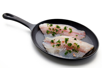 Two fillets of white fish, spilled with salt and chopped parsley