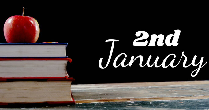 Image of 2nd january text over books and apple on black background - Powered by Adobe