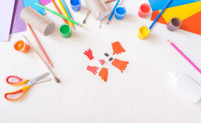 step2. Holiday easy DIY craft idea for kids. Toilet paper roll tube toy chick baby on a white...