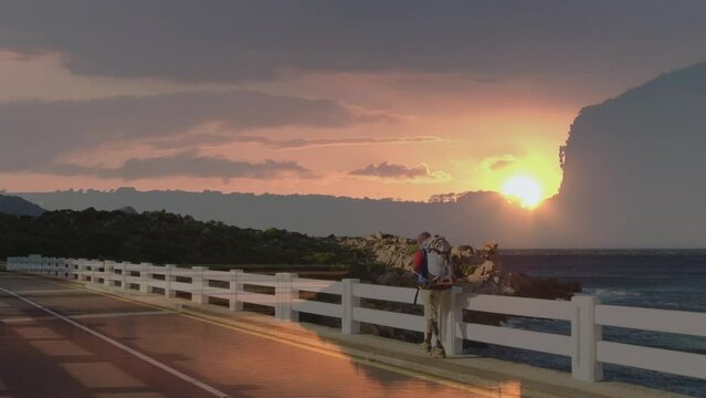 Sunset sky against diabled african american male hiker with prosthetic leg walking on the bridge