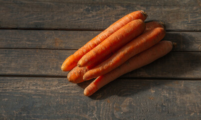 Carrots lie on wooden boards. Concept: market, vegetables, carrots