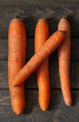 Carrots lie on wooden boards. Concept: market, vegetables, carrots