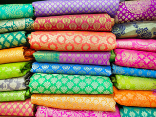 Rolls of fabric and textiles in shop. Multi colors indian patterns on the market Fabrics in rolls. Fabric store in Pune, Maharashtra, India.