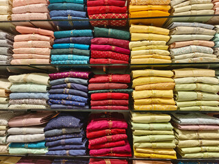 Indian men latest fashion dress hung on hangers, in display in retail shop in market, wedding wear for men India