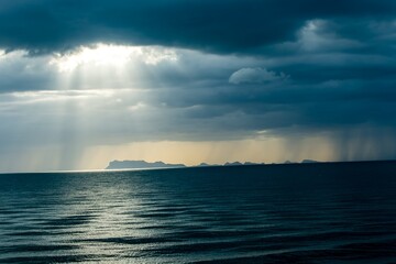 Rain Clouds over the ocean with heavenly rays of light