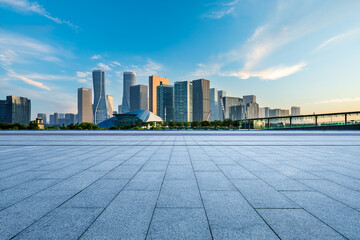 Fototapeta Empty square floor and city skyline with modern commercial buildings in Hangzhou at sunrise, China. obraz