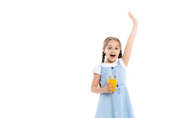 excited girl with orange juice standing with raised hand and screaming isolated on white.