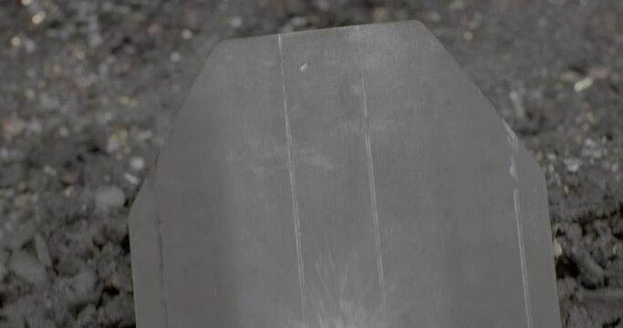 Body armor plate damage in a shooting range. Close up of gunshot marks. Armor-piercing testing of military equipment. 