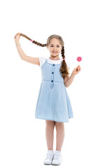 full length view of cheerful girl holding braid and lollipop on white.
