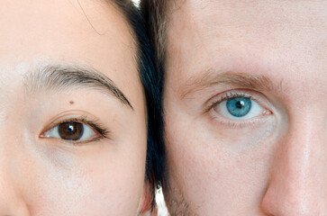 Close up portrait of asian woman and caucasian man. Face to face macro eyes. We are all for peace to the world