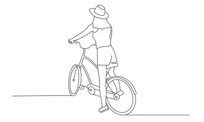 Young girl in a hat on a bike.