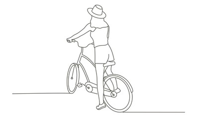 Fototapeta premium Young girl in a hat on a bike.