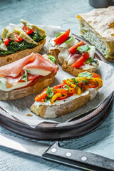 Italian food, Antipasto, Bruschetta, Baguette, Jamon, Prosciutto, Vegetables, Mushrooms, Prosciutto di Parma on Served Table, Restaurant Food