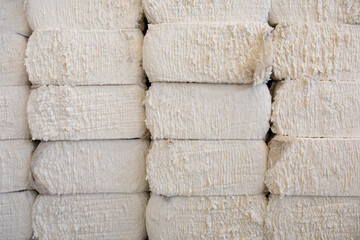 Pile or stack of cotton bales at textile factory or industry