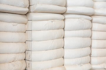 Pile or stack of cotton bales at textile factory or industry